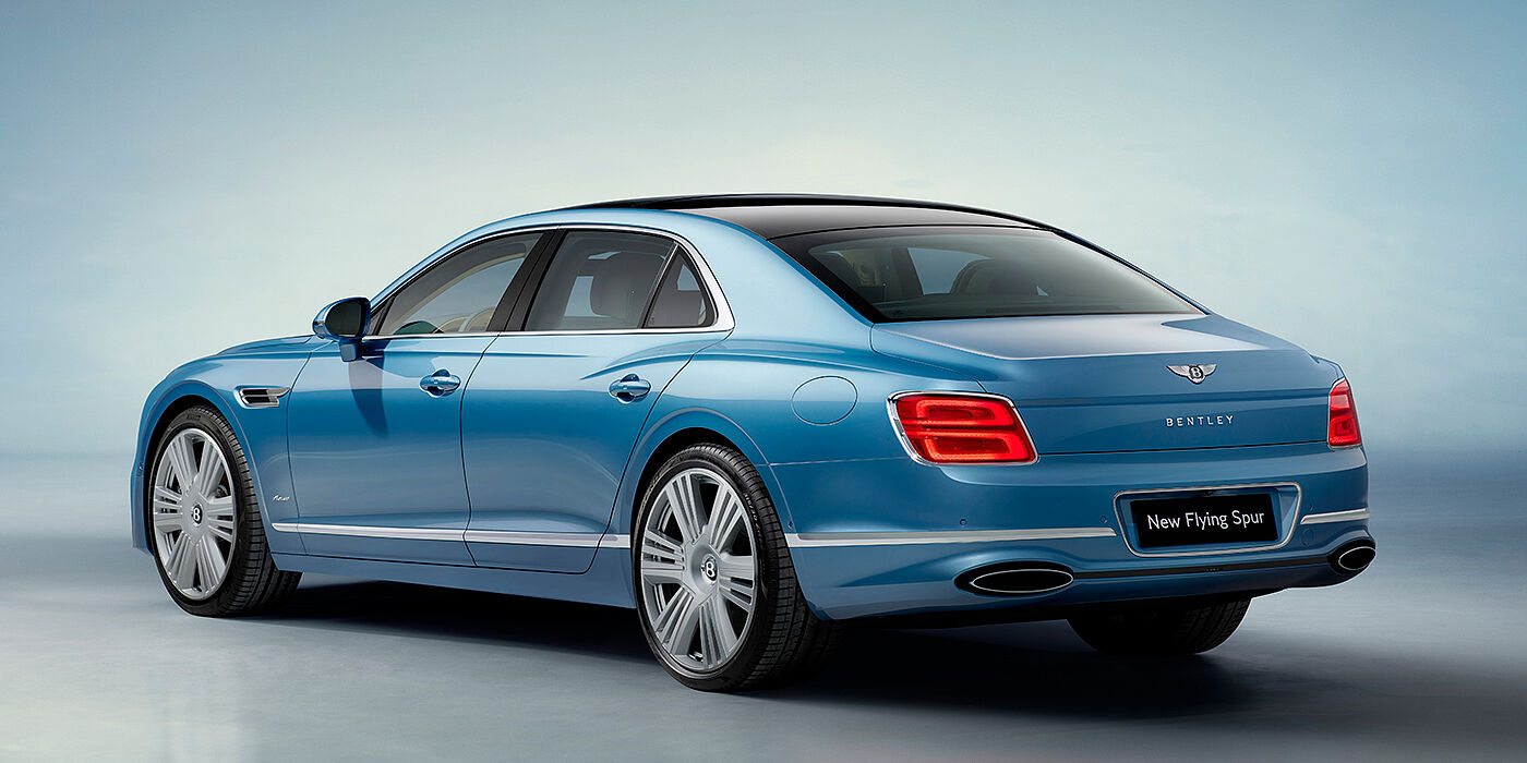 Bentley Belfast New Bentley Flying Spur Azure sedan rear view in Light windsor blue by Mulliner paint with 22 inch Azure wheels and chrome exterior details