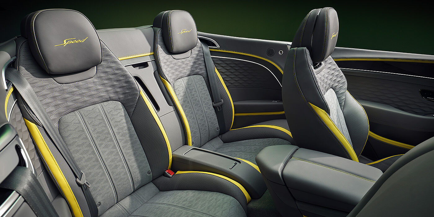 Bentley Belfast Bentley New Continental GTC Speed convertible rear interior with unique Speed colour split in Gravity Grey and Cyber Yellow hide colours, and contrast stitched headrest emblems 