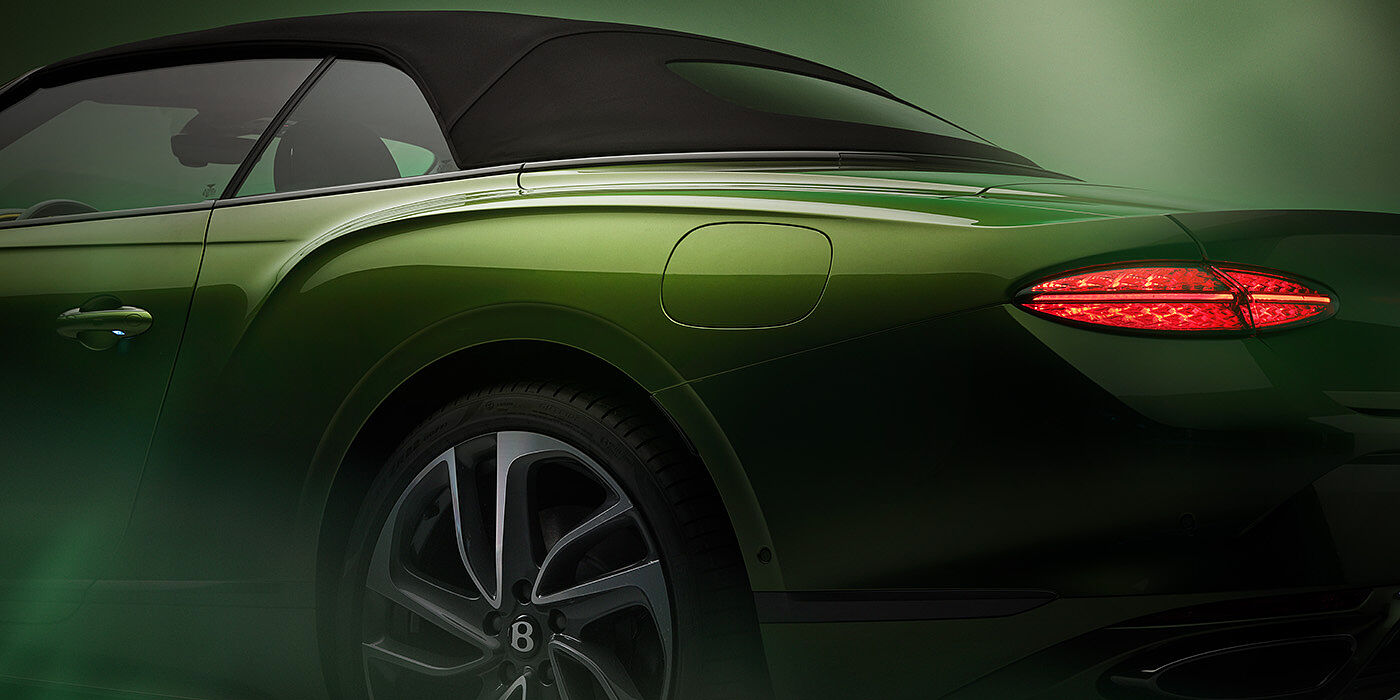 Bentley Belfast Bentley New Continental GTC Speed rear haunch and tail lamp in Tourmaline Green paint and dark tint brightware with black hood up and illuminated head lamps