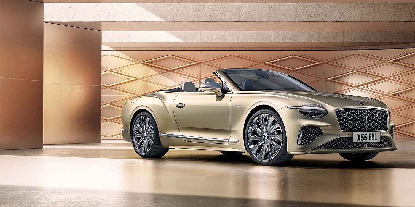 Bentley Belfast Bentley New Continental GTC Mulliner V8 hybrid front three quarters in Patina paint