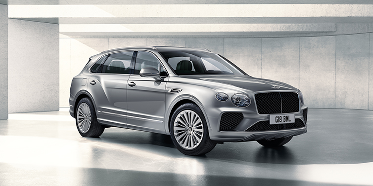 Bentley Belfast Bentley Bentayga Extended Wheelbase SUV front three quarter in Moonbeam paint with a grey background