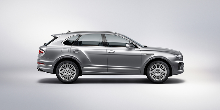 Bentley Belfast Bentley Bentayga SUV side profile in Moonbeam silver paint against white background featuring 21 inch 5 spoke wheels