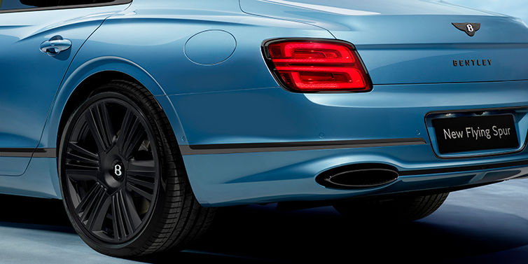 Bentley Belfast New Bentley Flying Spur Azure sedan in Light windsor blue by Mulliner paint and Black Specification, showing 22 inch Black Azure wheel, black exhaust pipes and exterior features