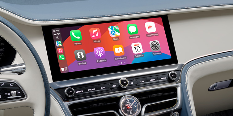 Bentley Belfast New Bentley Flying Spur Azure sedan front cabin central MMI screen showing available services against Linen and Brunel hides and Piano Linen veneer